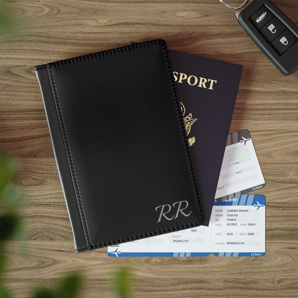 Elite Men's RFID Wallet sleek plain black bespoke passport cover with credit card sections showcased closed front facing on a table with a mock passport behind it