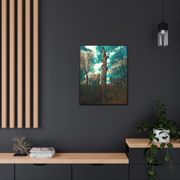 an image in a frame on wall of a single tree in the midst of other trees in the background and cloudy skies. the image has been enhanced for an excellent feel and finish. dark coloured wall for contrast